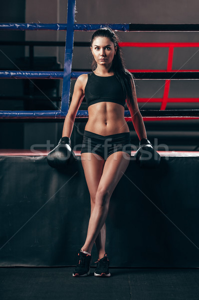 Stock photo: woman wearing boxing gloves sitting near ring