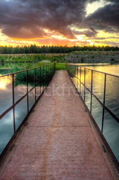 Hierro Rusty puente puesta de sol cielo agua Foto stock © chesterf