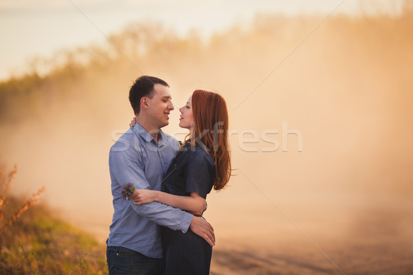 couple embracing standing on the road in the dust Stock photo © chesterf
