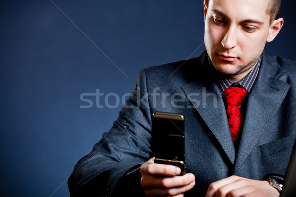 businessman holding phone Stock photo © chesterf