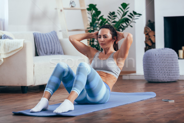 mid adult woman training abdominals at home Stock photo © chesterf