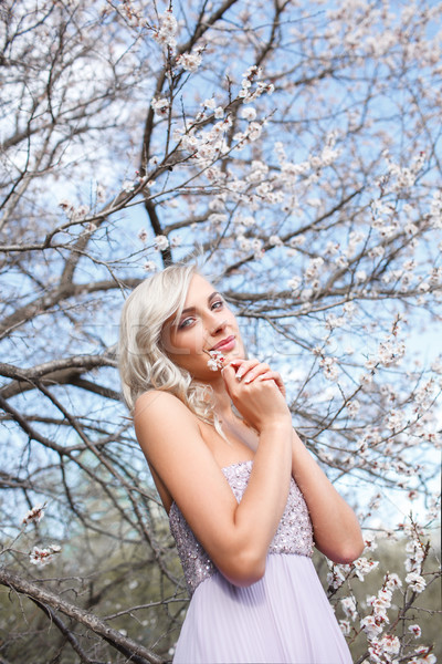 Stock photo: blonde woman in a flowered garden
