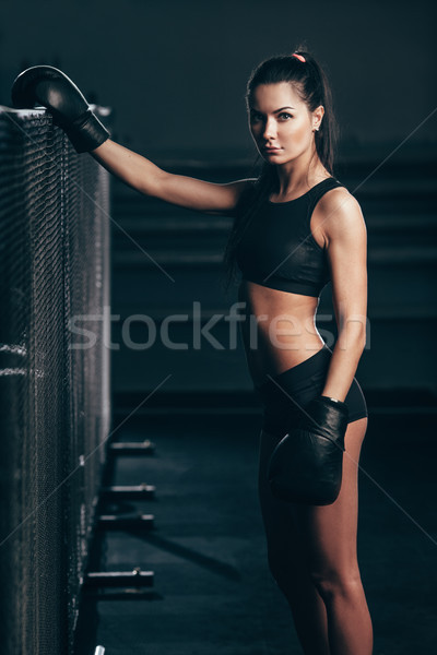 woman wearing boxing gloves sitting near ring Stock photo © chesterf