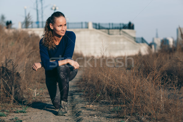 Young woman stretching before her run outdoors Stock photo © chesterf