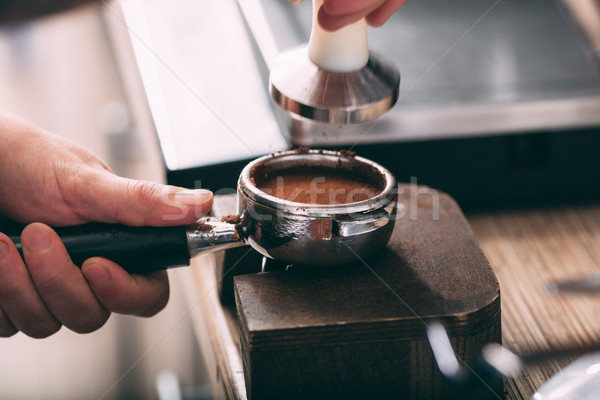 Barista pressing coffee in the machine holder Stock photo © chesterf
