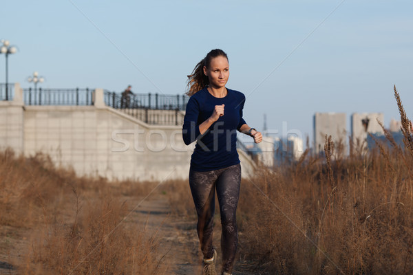 woman running outdoors on a cold fall day Stock photo © chesterf