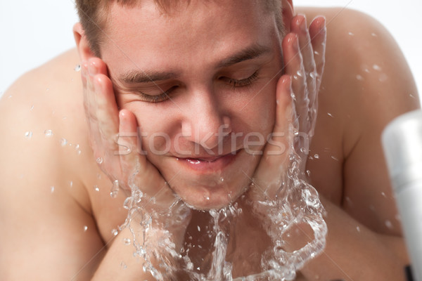 young man washing his face Stock photo © chesterf