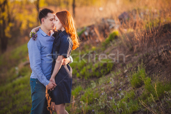 couple kissing standing outdoos among bushes Stock photo © chesterf