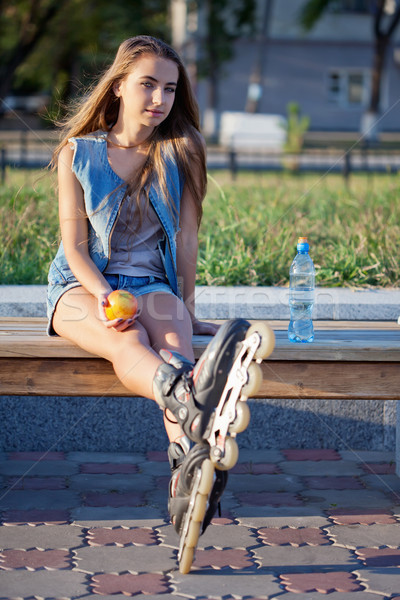 smiling roller girl sitting on the bench Stock photo © chesterf