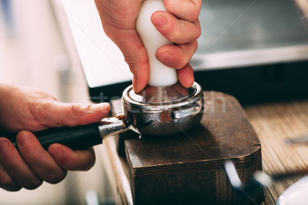 Barista pressing coffee in the machine holder Stock photo © chesterf