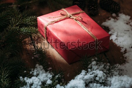 red gift box and fur tree on wooden background Stock photo © chesterf