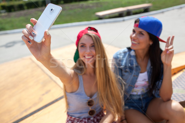 girlfriends taking a selfie photo on the skate park Stock photo © chesterf