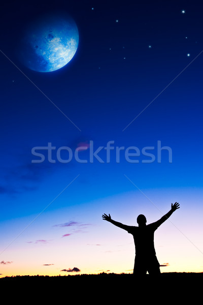 man rising hands under the moon Stock photo © chesterf
