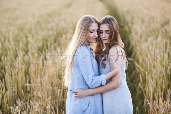 Stock photo: beautiful young mother and her daughter at the wheat field