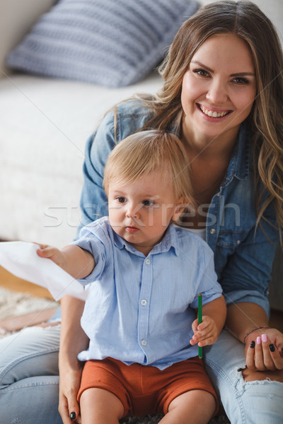 Mother and son paint the walls and floor. Children's creativity. Stock photo © chesterf