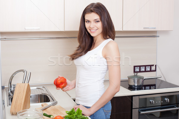 woman preparing salad at her kitchen Stock photo © chesterf