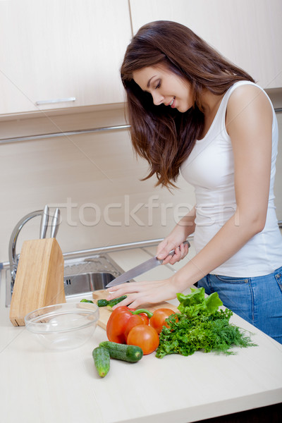 Smiling woman preparing salad Stock photo © chesterf
