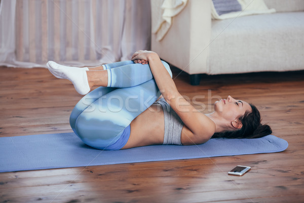 Young cheerful attractive woman practicing yoga Stock photo © chesterf