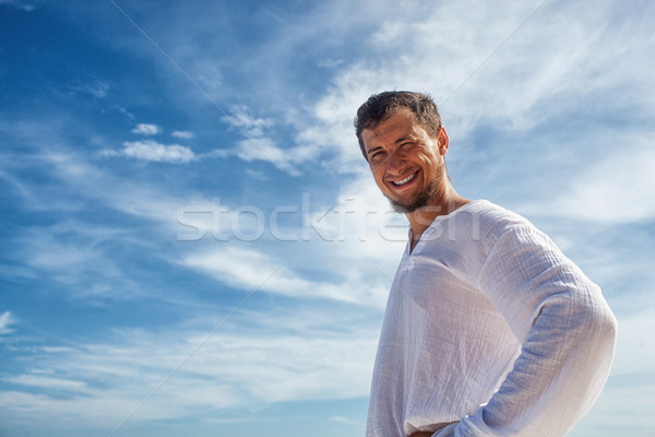 Stock photo: man standing before blue skies with clouds