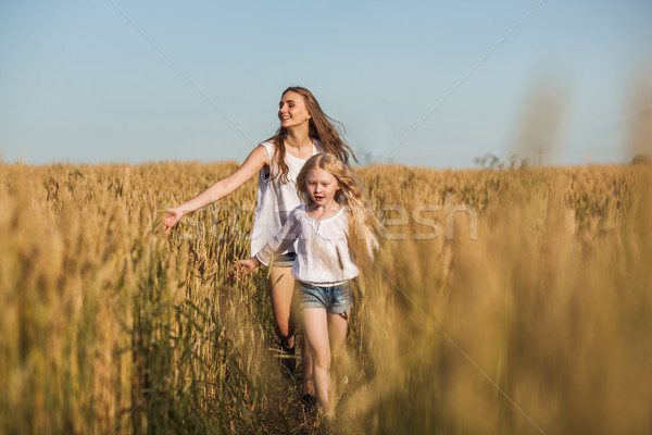 two sisters running on wheat filed Stock photo © chesterf