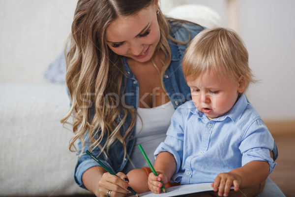 Mother and son paint the walls and floor. Children's creativity. Stock photo © chesterf