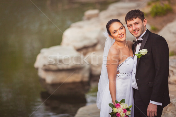Menyasszonyi pár áll tó kövek esküvő Stock fotó © chesterf