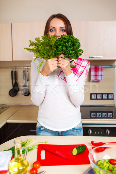 Smiling young housewife mixing fresh salad Stock photo © chesterf