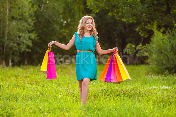 happy woman at park with shopping bags Stock photo © chesterf