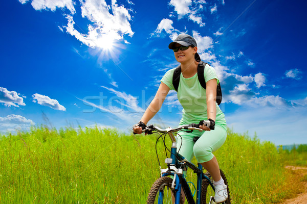 woman with bike on green field Stock photo © chesterf