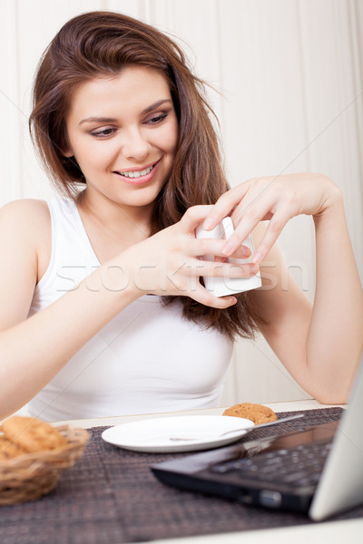 Happy woman enjoying tea and cookies Stock photo © chesterf