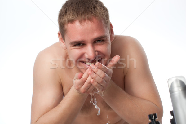 young man washing his face Stock photo © chesterf