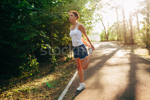 Stock photo: yong sporty woman streching her leg