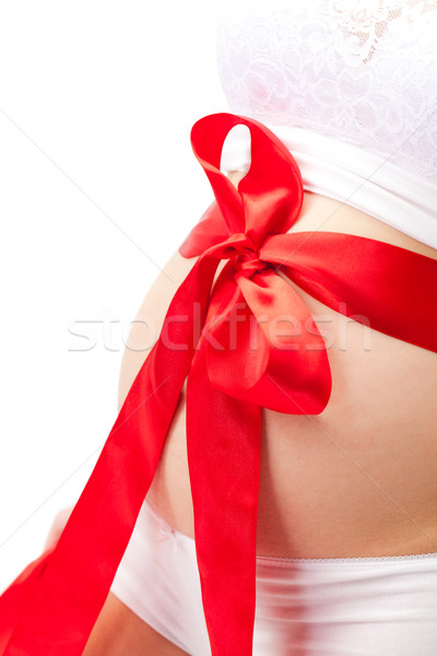 pregnant woman belly with red bow Stock photo © chesterf