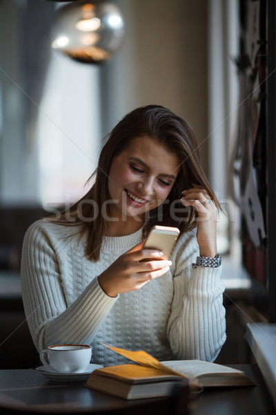 woman using her mobile phone at cafe Stock photo © chesterf