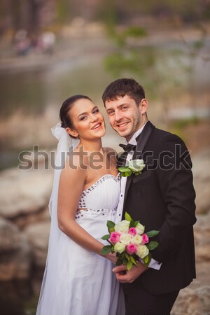 happy bridal couple in park Stock photo © chesterf