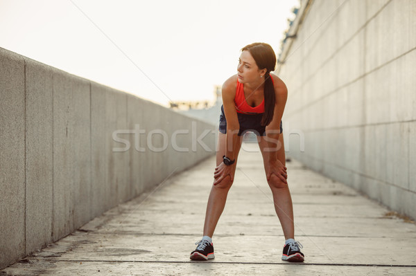 Young caucasian woman taking breath after jogging Stock photo © chesterf