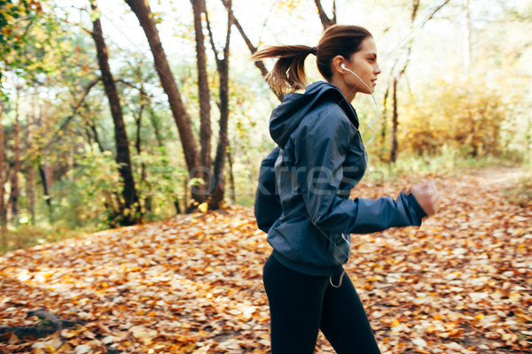  Runner woman jogging in autumn park. Motion blur effect Stock photo © chesterf
