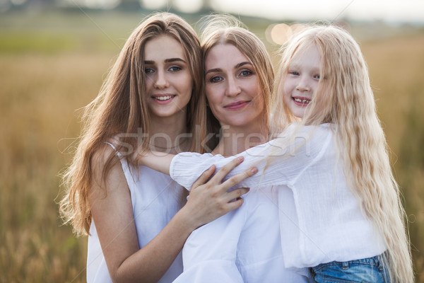 beautiful young mother and her daughters at the wheat field Stock photo © chesterf