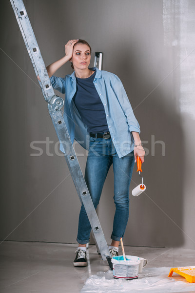 Cansado mujer trabajo casa pintura pared Foto stock © chesterf