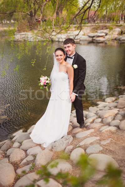 Menyasszonyi pár áll tó kövek esküvő Stock fotó © chesterf