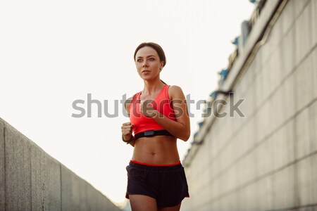 woman runnning along concrete wall Stock photo © chesterf