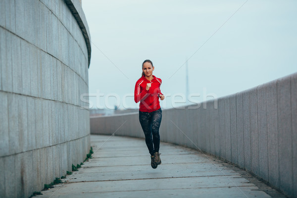 woman running in concrete urban scape Stock photo © chesterf
