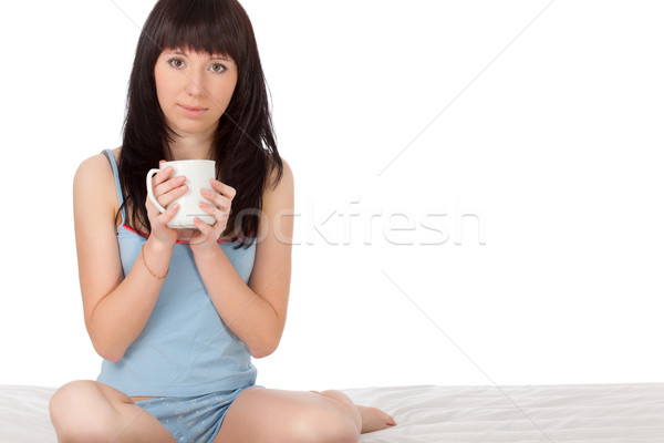 Stock photo: woman sitting on bed