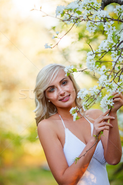 blonde woman in a flowered garden Stock photo © chesterf