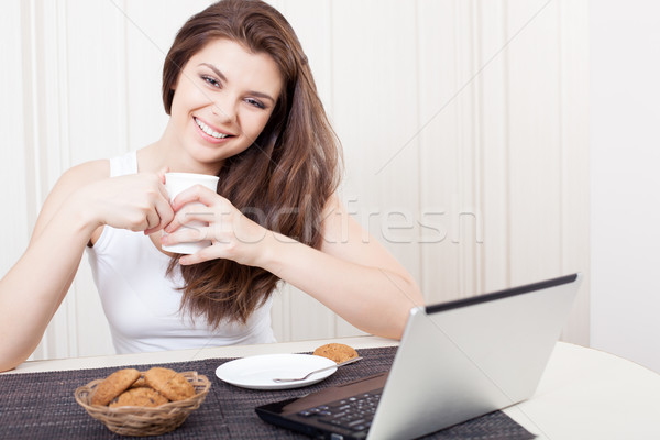 Happy woman enjoying tea and cookies Stock photo © chesterf