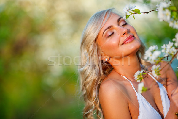 blonde woman in a flowered garden Stock photo © chesterf