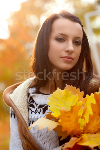 brunette holding oak leaves Stock photo © chesterf