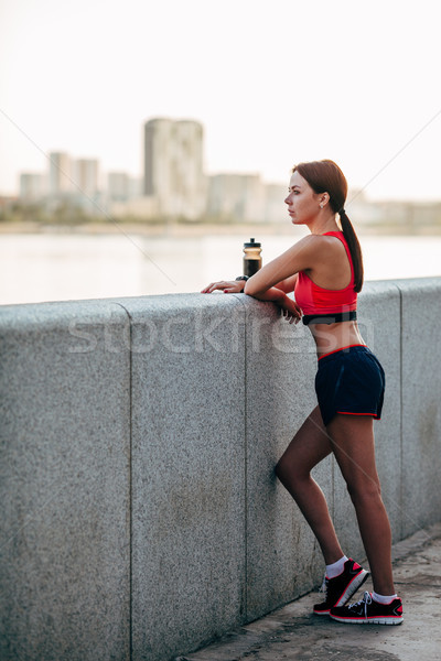 Femminile runner acqua in bottiglia stanco esecuzione piedi Foto d'archivio © chesterf