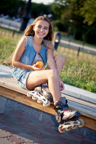 smiling roller girl sitting on the bench Stock photo © chesterf