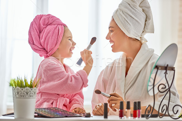 Mother and daughter are doing make up Stock photo © choreograph